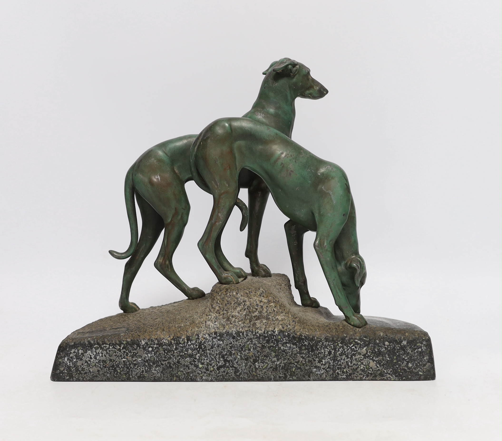 An early 20th century patinated spelter model of two hounds on a granite base, 29cm
